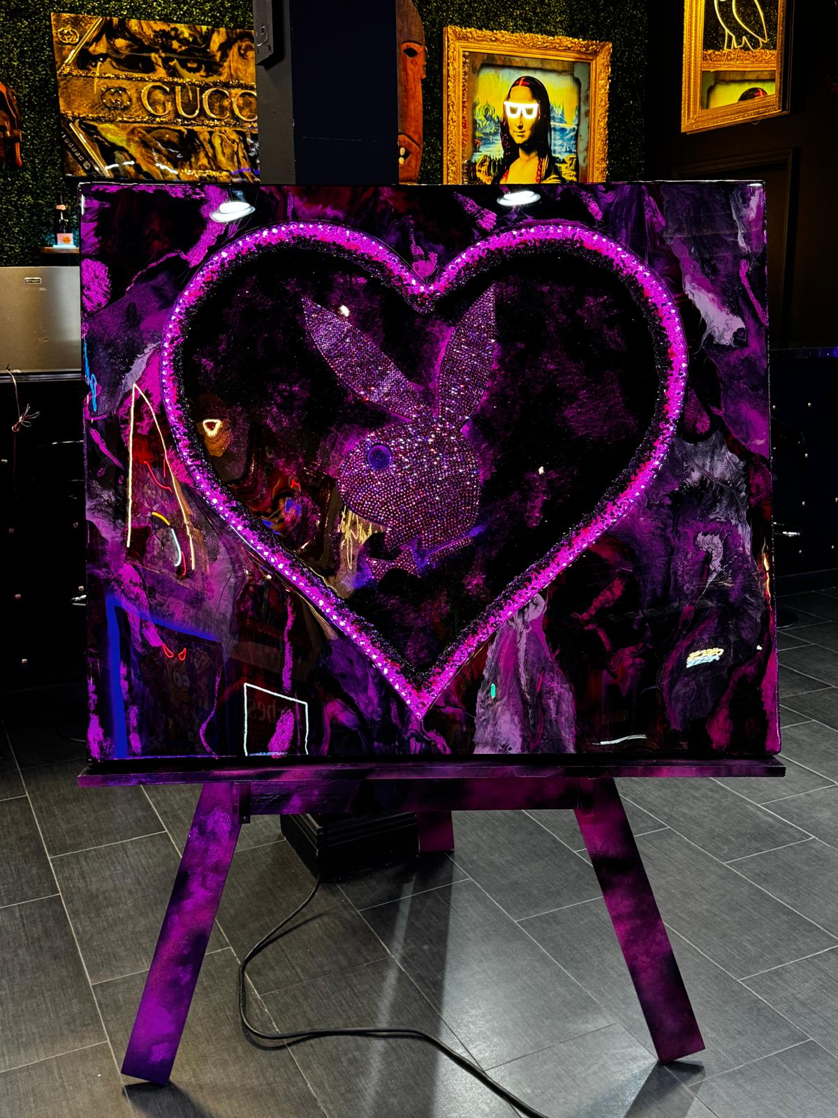 High-gloss epoxy artwork featuring a Swarovski crystal-embellished playboy emblem in pink